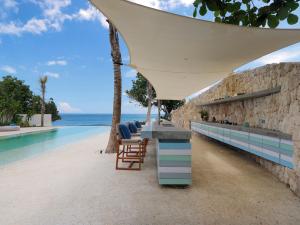 a table and chairs next to a swimming pool at Villa Seascape by Elite Havens in Nusa Lembongan