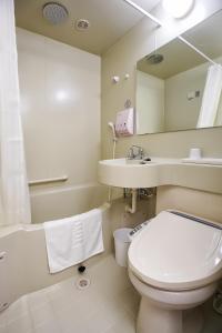 a bathroom with a toilet and a sink and a mirror at Toyoko Inn Seoul Gangnam in Seoul