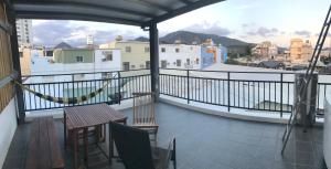 a balcony with a table and a view of a city at Living House in Hengchun
