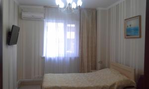 a bedroom with a bed and a window at Hotel Shagyn in Astana