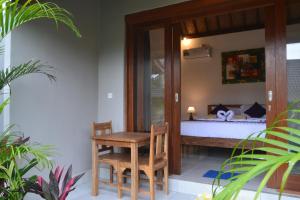Postel nebo postele na pokoji v ubytování Buda Cottage Ubud