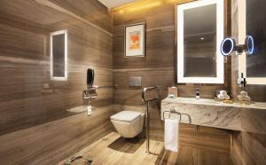 
a bathroom with a toilet a sink and a bathtub at Hilton Chengdu in Chengdu
