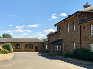 a brick building with a driveway in front of it at Seawell in Towcester