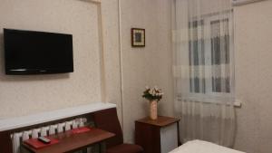 a hotel room with a television on the wall at Hotel Shagyn in Astana