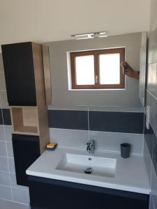 a bathroom with a sink and a window at Champagnac in Borrèze +10 photos