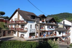 a large white building with balconies on a hill at Haus Mühlenruh in Bruttig-Fankel