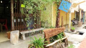 un banc en bois assis devant un bâtiment dans l'établissement Pangkor Guesthouse SPK, à Île de Pangkor