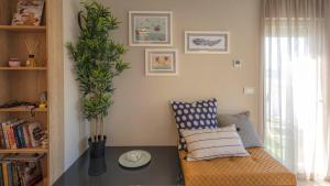 a living room with a chair and a plant at Nikky’s BLUE DREAM Apartment in Mali Lošinj