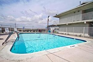 a large swimming pool in front of a building at Hilltop Inn & Suites in Victorville