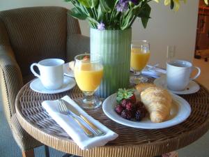 a table with a breakfast of croissants and orange juice at Southbridge Napa Valley in St. Helena