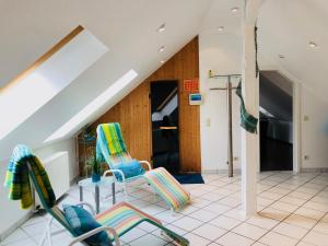 a room with two chairs and a table at Waldhaus Oelper in Braunschweig