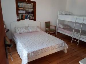 a bedroom with a bed and two bunk beds at Guesthouse Mare Bar in Bar
