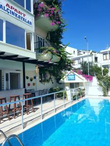 a hotel with a swimming pool in front of a building at Yalcinkayalar Aparthotel in Datca