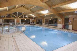 a large swimming pool in a large building at Tegid Lodge- Pine Lake Resort in Carnforth