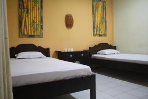 Postel nebo postele na pokoji v ubytování De Puspa Residence Seminyak