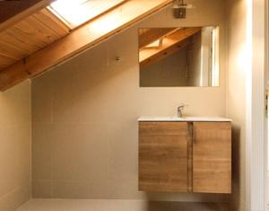 a bathroom with a sink and a mirror at Yasemi Rooms in Vasiliki