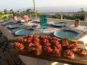 a table with plates of food on top at Piqeras Relax Guest House in Piqeras