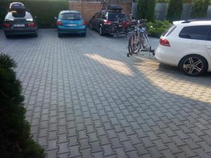 a bike parked in a parking lot with cars at Casa Aurora in Turda