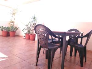mesa de comedor con 2 sillas y plantas en Ático con solarium en El Campello, en El Campello
