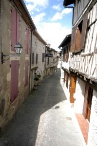 un callejón vacío en un viejo pueblo con edificios en L' Ancien Relais de Poste Henri, en Casteljaloux