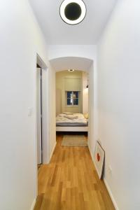 a hallway leading to a bedroom with a bed at Jadranka in Zagreb
