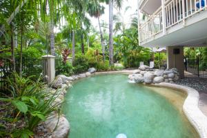 a swimming pool in a yard with a house at Seascape Holidays - Driftwood Mantaray in Port Douglas