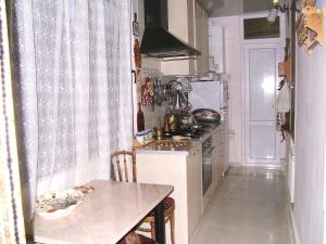 a small kitchen with a table and a counter top at Tina's Homestay in Tbilisi City