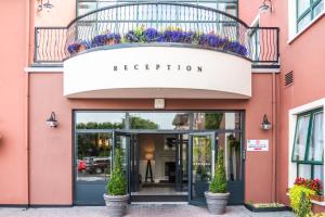 a pink building with a sign that reads reception at Clonakilty Park Hotel in Clonakilty