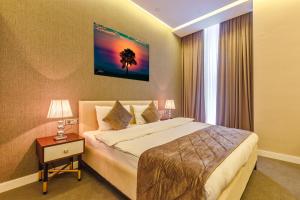 a hotel room with a bed and a window at Aksent Hotel in Baku