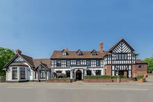 a large brick building with a clock on the front of it at Elephant Hotel in Pangbourne