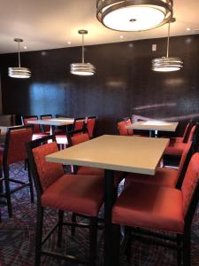 a dining room with tables and chairs and lights at Black Gold Suites Tioga in Tioga