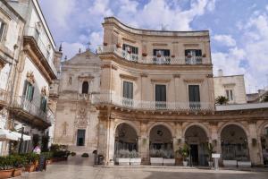 a large building with a balcony on top of it at nonna annina in Martina Franca