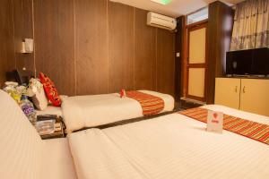 Postel nebo postele na pokoji v ubytování Traveler's Holiday Inn