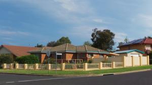 a house with a fence on the side of the road at The Garden House in Tamworth