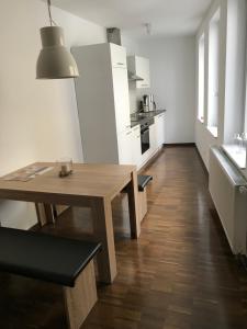 a small kitchen with a wooden table in a room at F & W Apartment in Erfurt