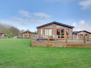 a home with a deck and a house at Cackle hill lakes in Biddenden