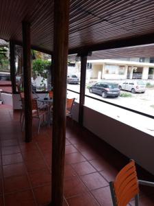a porch with a view of a parking lot with cars at Fidgi in Nea Kalikratia