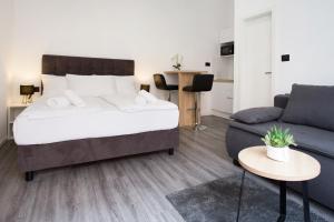 a bedroom with a bed and a couch at SENZACIJA apartments in Split