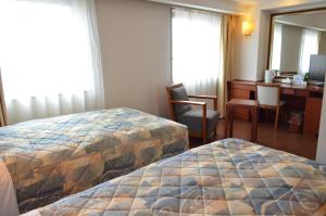 Ένα ή περισσότερα κρεβάτια σε δωμάτιο στο Yokohama Mandarin Hotel