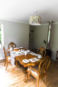 a dining room with a wooden table and chairs at The Forge Bed & Breakfast in Auchterarder