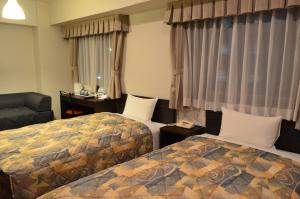 Ένα ή περισσότερα κρεβάτια σε δωμάτιο στο Yokohama Mandarin Hotel