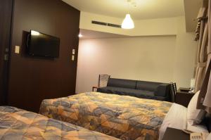 Ένα ή περισσότερα κρεβάτια σε δωμάτιο στο Yokohama Mandarin Hotel