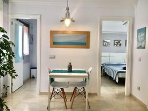 a dining room with a table and a bed at Apartamento beach house in Las Palmas de Gran Canaria