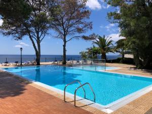 a swimming pool with a view of the ocean at Albatroz Beach & Yacht Club in Santa Cruz