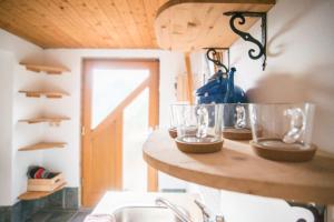 a kitchen with a sink and a counter with glasses on it at Nature nook in Bled
