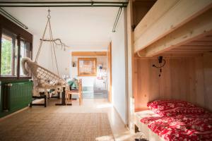 a bedroom with a loft bed and a swing at Nature nook in Bled
