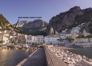 a view of a town next to a body of water at ENZA ROOM'S AMALFI COAST affittacamere in Amalfi