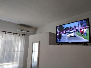 a flat screen tv hanging on a wall in a living room at Kuća za odmor Matko House Matko in Pag
