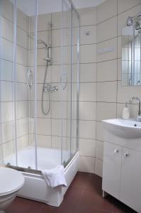 a bathroom with a shower and a toilet and a sink at Willa Ewa in Międzyzdroje +58 photos