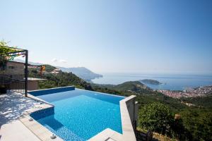 a swimming pool with a view of the ocean at Villas Adriatic Horizonte in Budva